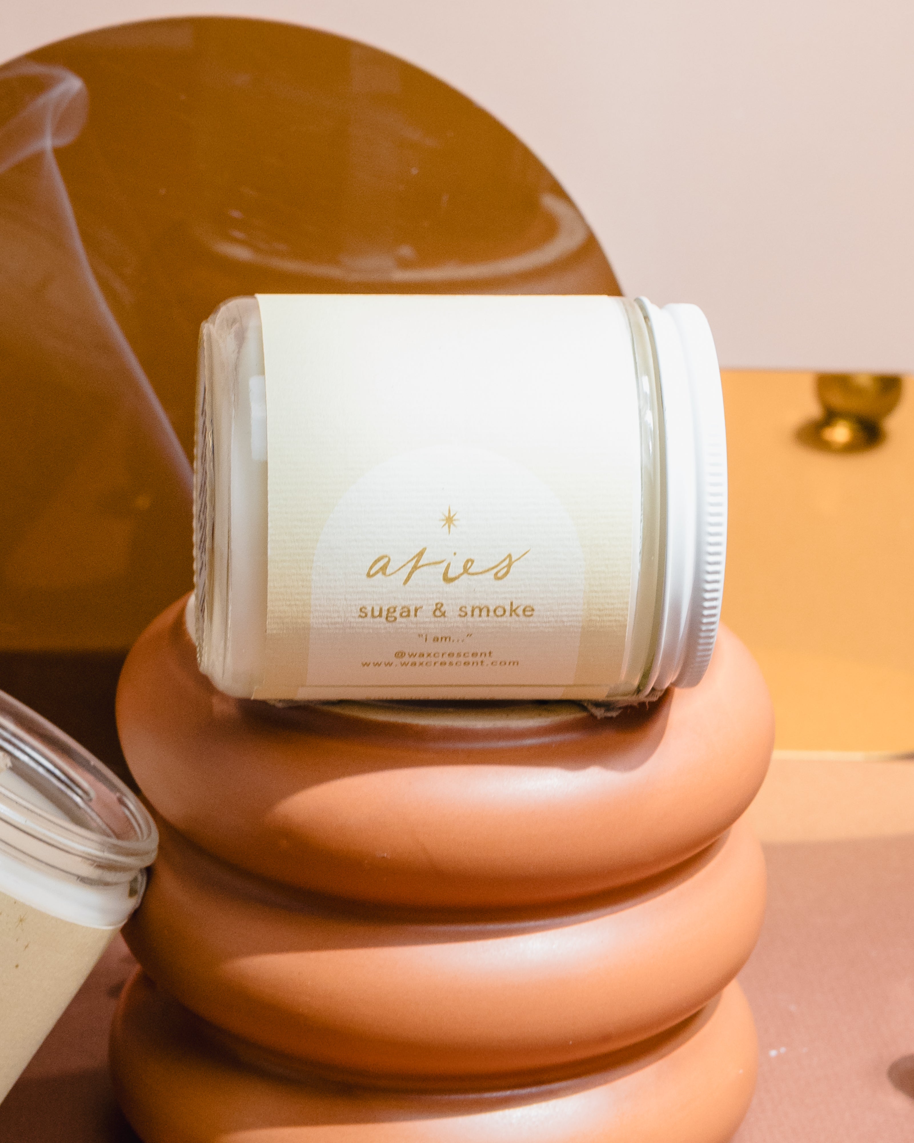 Aesthetic product photo of Wax Crescent’s Aries candle featuring minimalist astrology design and warm-toned backdrop