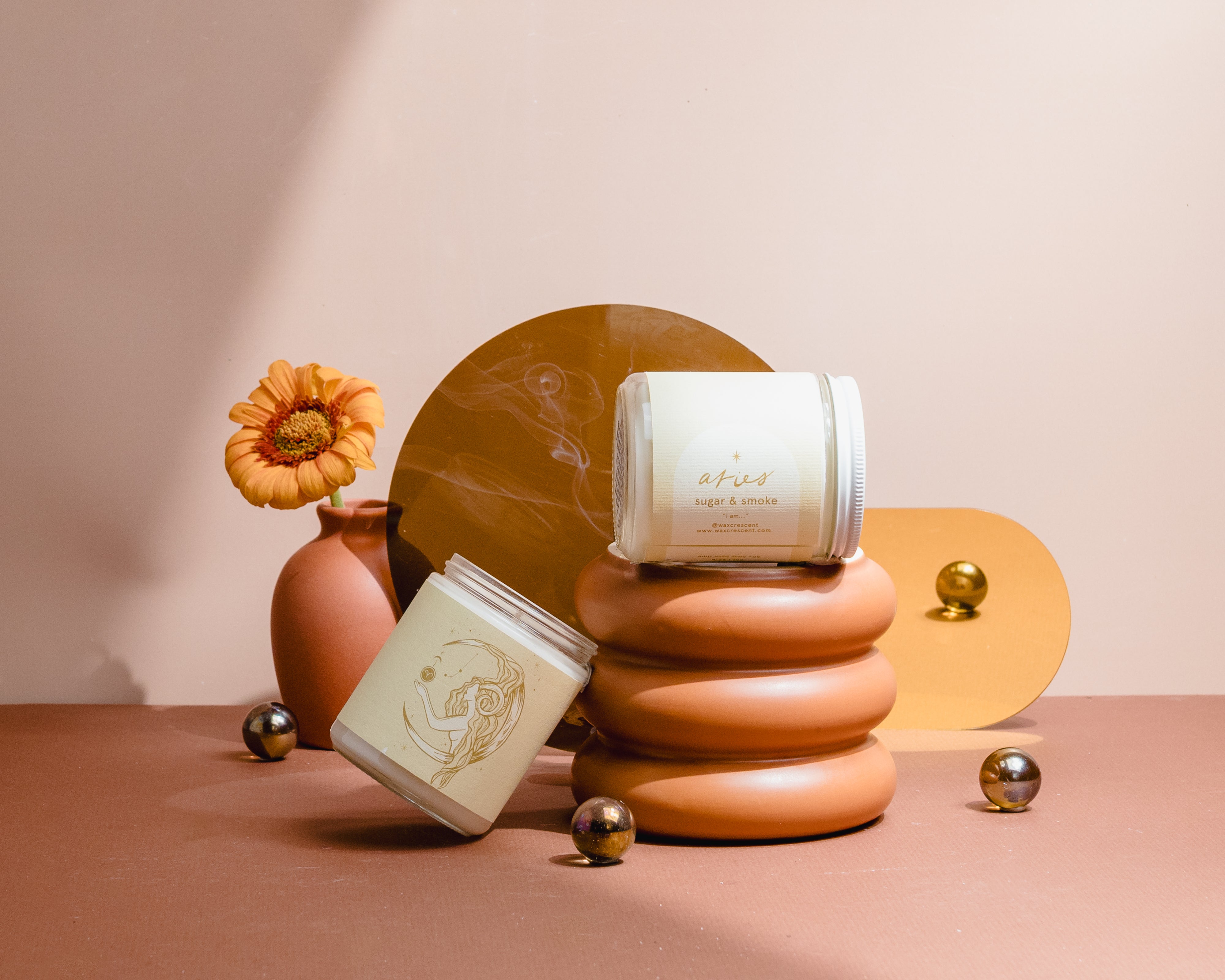 Luxury Aries astrology candle with illustrated label and smoke curling in the background, styled for modern home decor