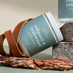 Close-up of Wax Crescent Tobacco & Teakwood candle featuring leather, bark, and earthy tones. A luxury soy candle for a warm and inviting atmosphere