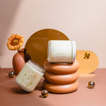 Aries zodiac candle with Sugar & Smoke scent styled with terracotta and gold accents