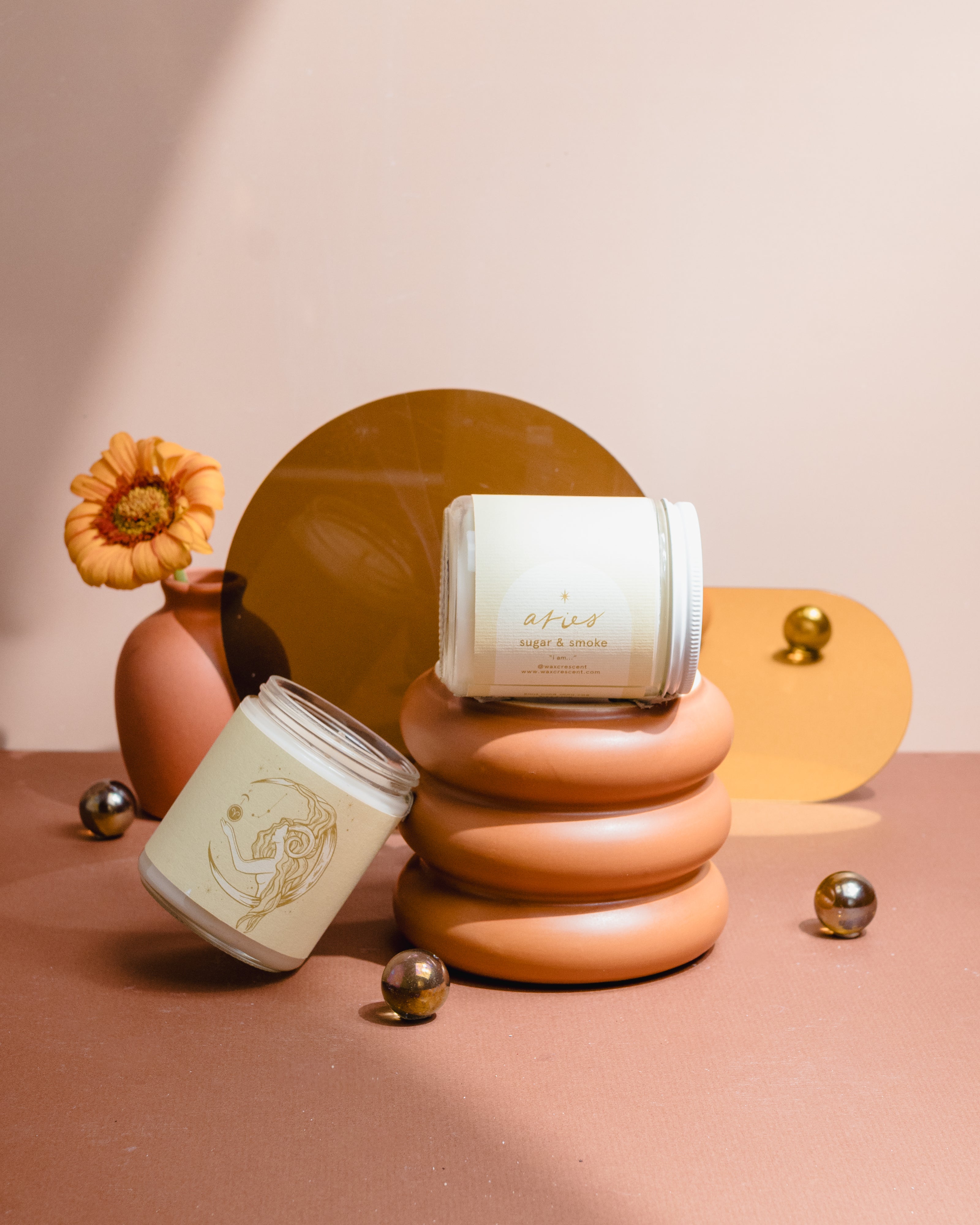 Aries zodiac candle with Sugar & Smoke scent styled with terracotta and gold accents