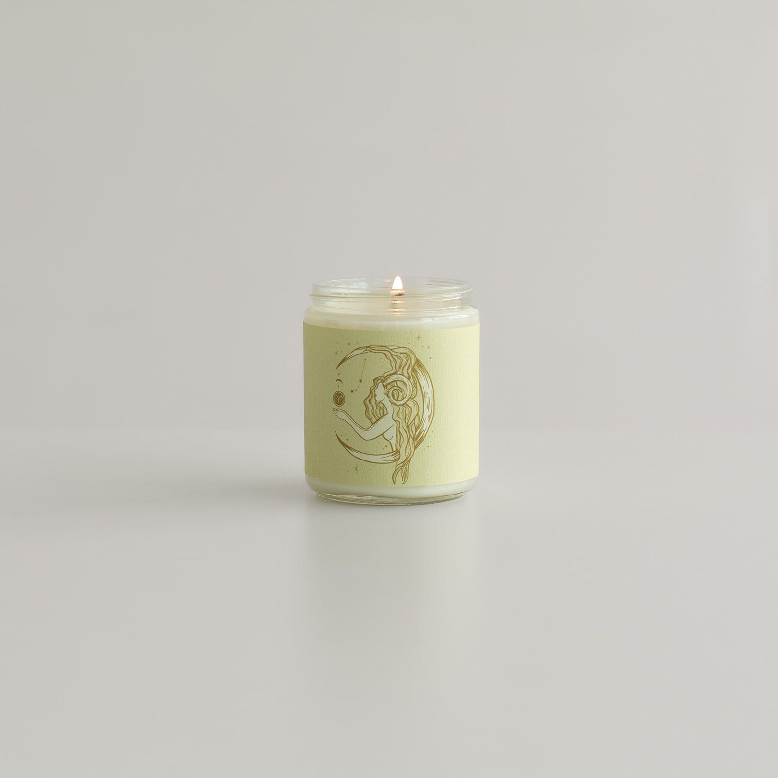 Aries Zodiac soy wax candle in a minimalist glass jar, showcasing the Wax Crescent logo, hand-poured with vibrant, bold scents reflecting the fiery Aries spirit. Perfect for astrology enthusiasts and home decor, made from eco-friendly soy wax.moon
