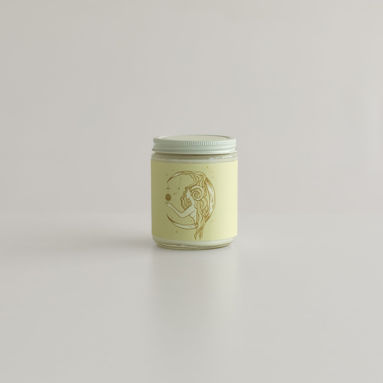 Top view of the lit Aries Zodiac candle, hand-poured with botanical scents, capturing its smooth, creamy wax and minimalist design. A perfect home accent for astrology lovers and fans of eco-conscious, non-toxic candles.