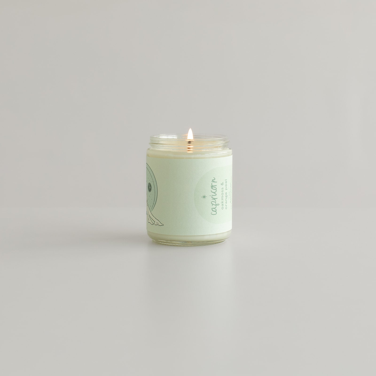capricorn zodiac candle woman with goat horns on jar and astrology symbol