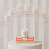 gemini astrology candle on a stack of books for zodiac season
