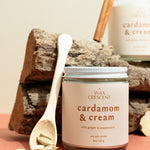 Cardamom & Cream candles styled with cinnamon and cardamom on wood — elegant non-toxic holiday candles hand-crafted by Wax Crescent, the perfect cozy gift for the season.