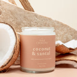 Wax Crescent Coconut & Santal soy candle paired with fresh coconut and wooden elements, creating a serene and earthy aesthetic against a light, minimal background
