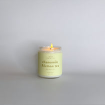 Chamomile & Lemon Tea luxury soy candle, lit and showcasing its calming, tea-inspired aroma with soothing notes of chamomile and lemon