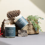 Juniper & Cypress candles on a neutral background styled with winter greenery — elegant, non-toxic holiday candles hand-poured by Wax Crescent, perfect for seasonal gifting