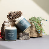 Juniper & Cypress candles on a neutral background styled with winter greenery — elegant, non-toxic holiday candles hand-poured by Wax Crescent, perfect for seasonal gifting