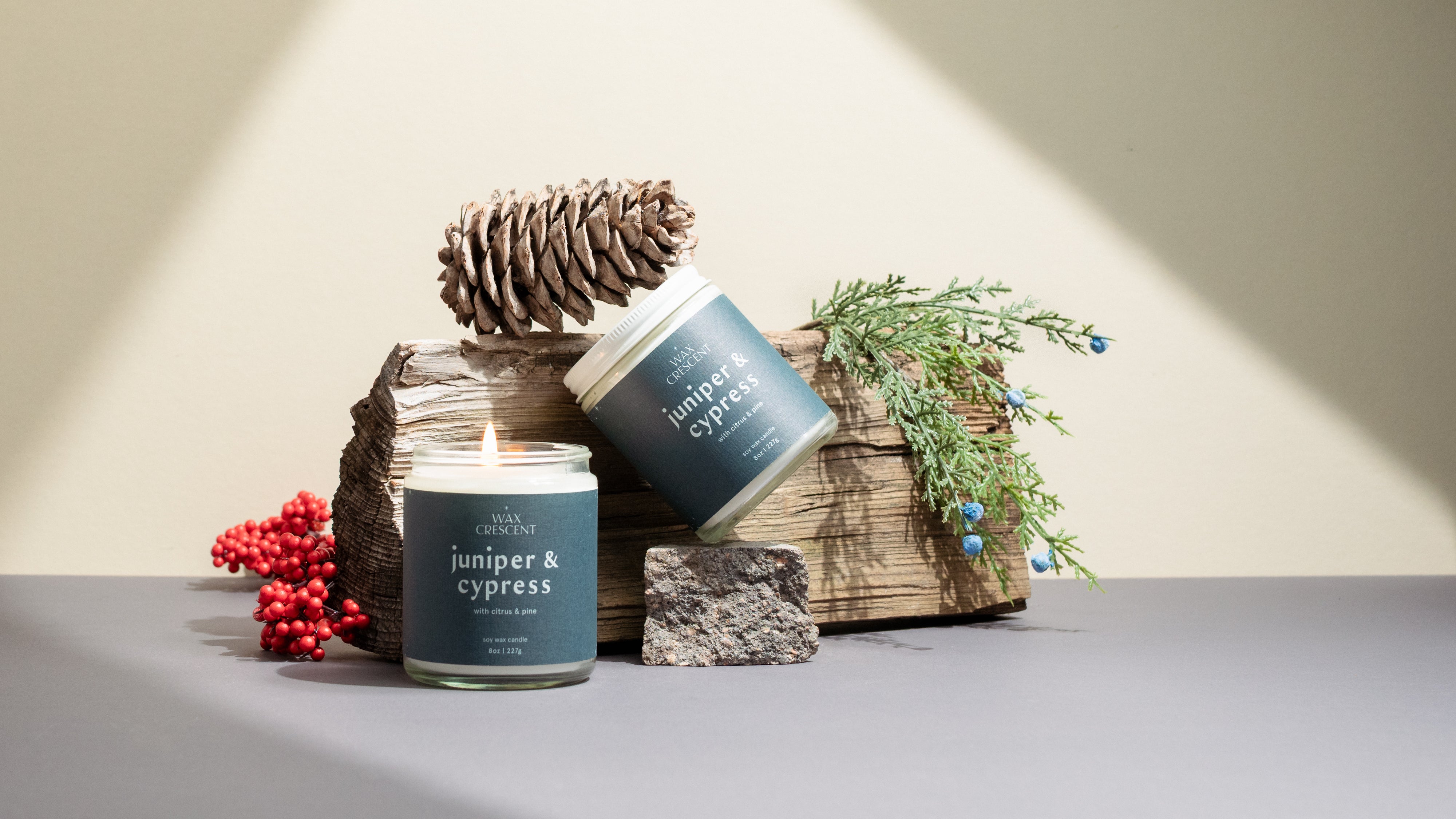 Juniper & Cypress candles on a neutral background styled with winter greenery — elegant, non-toxic holiday candles hand-poured by Wax Crescent, perfect for seasonal gifting