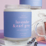 Two lavender and earl grey candles with a lavender flower on a purple background