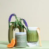 Wax Crescent Matcha & Lemongrass soy candle with green tea, orange, and jasmine notes, styled with greenery and a matcha latte for a refreshing, non-toxic ambiance.