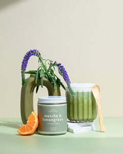 Wax Crescent Matcha & Lemongrass soy candle with green tea, orange, and jasmine notes, styled with greenery and a matcha latte for a refreshing, non-toxic ambiance.