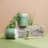 Pair of Olive Leaf & Bergamot candles on a neutral backdrop surrounded by olives and leaves — small-batch soy candles from Wax Crescent that bring fresh, botanical warmth to any space.