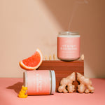 Candle with 'Red Ginger & Cardamom' scent on a pink background