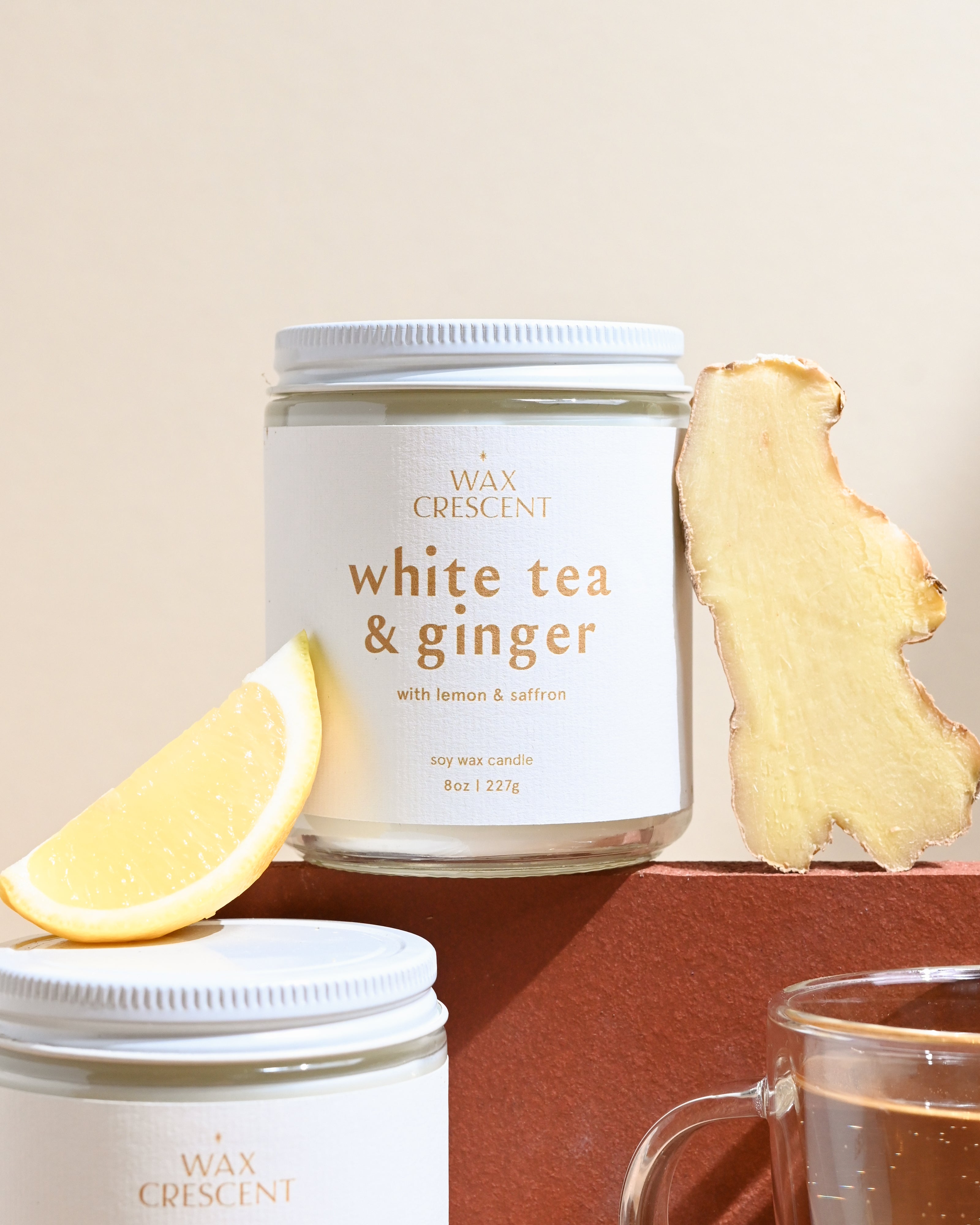 Close-up of Wax Crescent White Tea & Ginger candle with lemon and ginger, highlighting its refreshing, hand-poured design and sophisticated aroma.