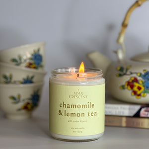 chamomile and lemon tea soy wax nontoxic candle and a tea pot and tea cups 