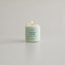 Vetiver & Fig Soy Wax Candle Lit on a White Background - Hand-Poured in Boulder, Colorado, with Non-Toxic Ingredients for a Sustainable Home Fragrance Experience.