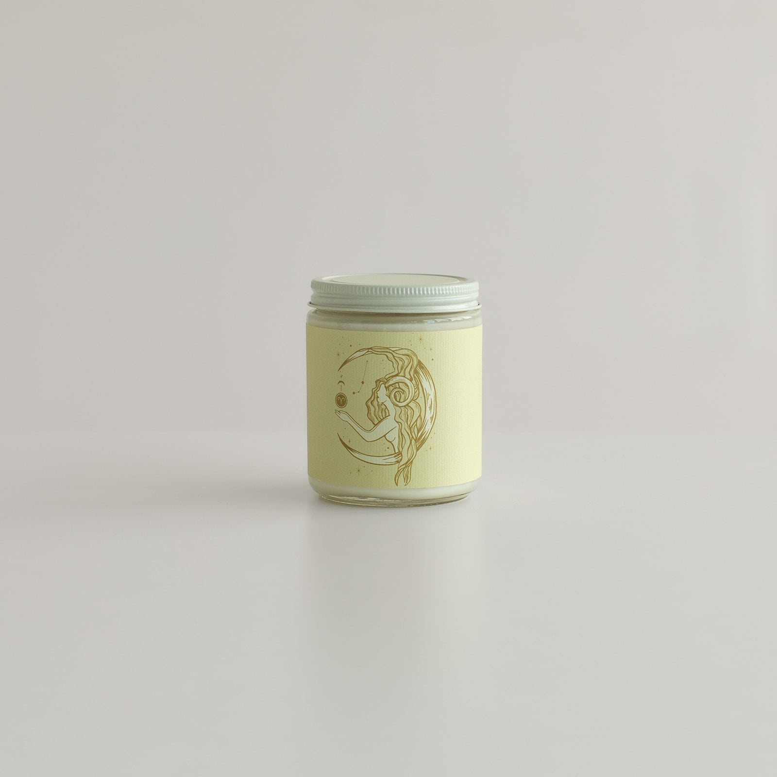 Aries season birthday candle with ram and crescent moon in a candle jar