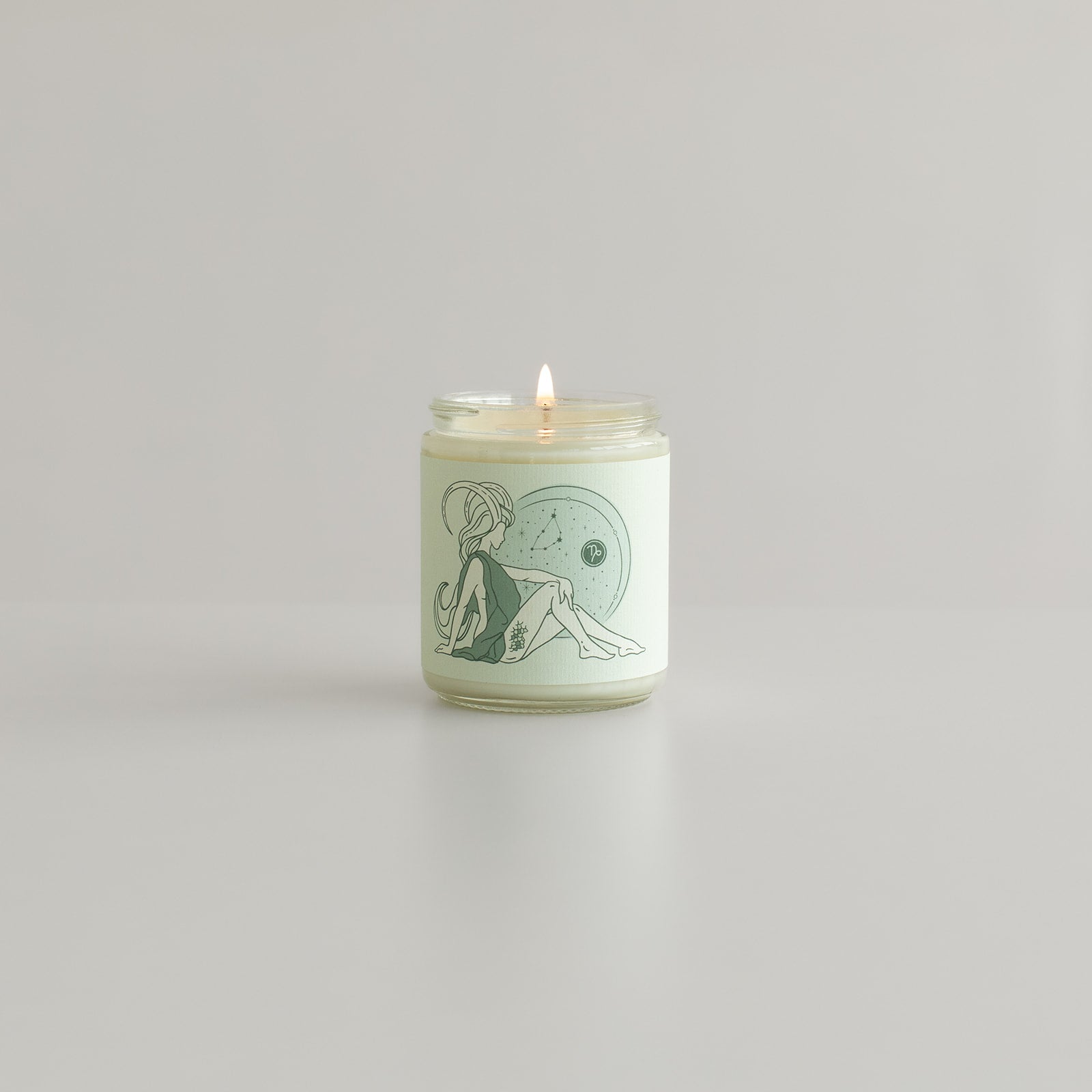 Capricorn astrology candle from zodiac features woman with goat horns on candle jar