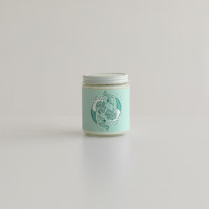 pisces astrology candle with two mermaids on candle jar 