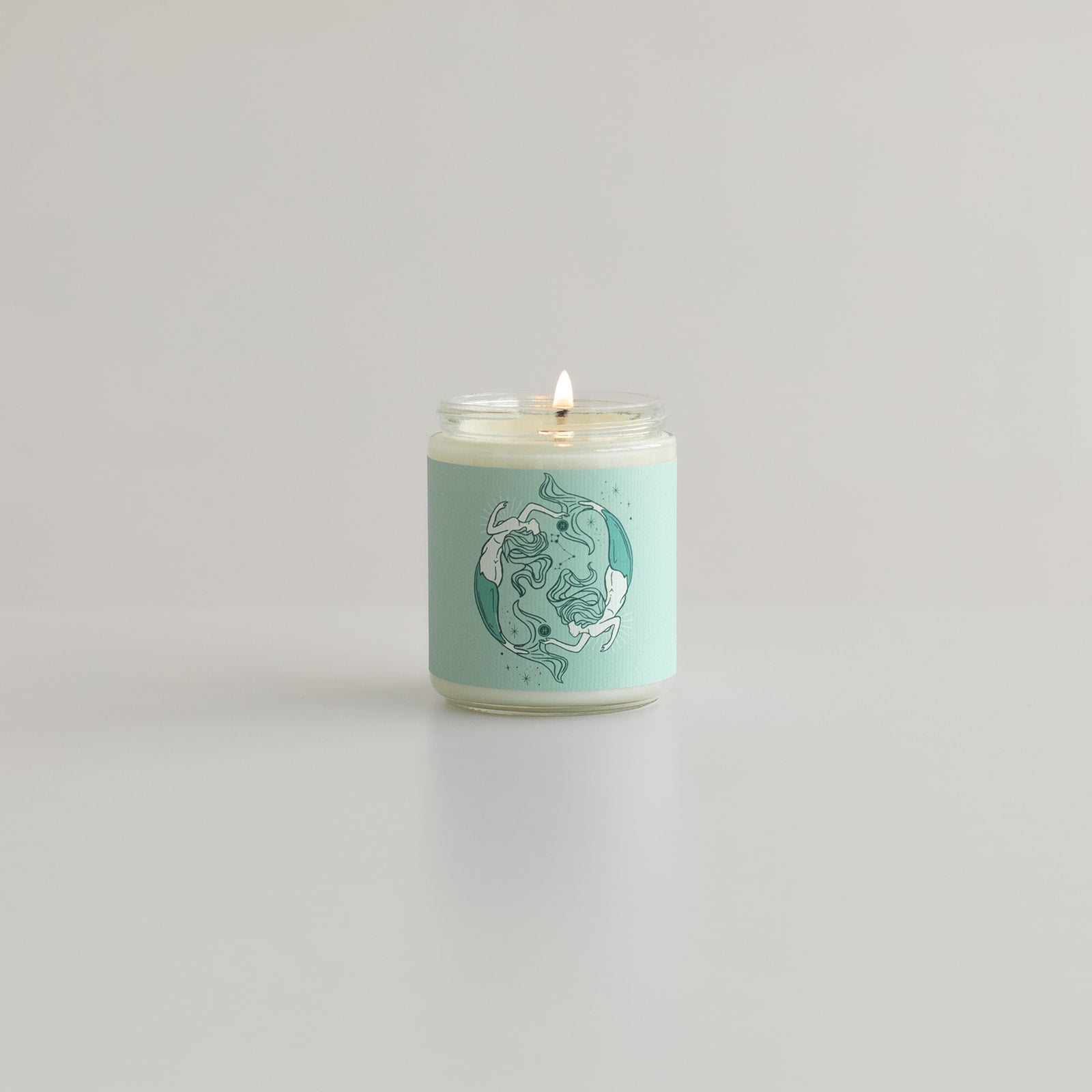 pisces astrology candle with two mermaids on candle jar and zodiac symbol